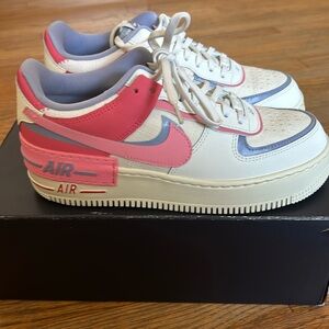 Nike Women's Air Force 1 Shadow
⁦Color⁩: Sail/Sea Coral/Indigo Haze/Coral Chalk